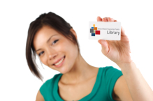 Smiling woman holding a BTPL library card