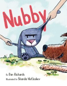 Book cover for Nubby. Two hands pull a blue stuffed bunny in different directions.