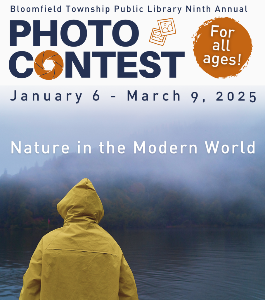 Bloomfield Township Public Library Ninth Annual Photo Contest. January 6 - March 9, 2025. Photo of person in yellow jacket facing mountains with trees.