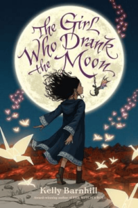 The cover of Kelly Barnhill's The Girl Who Drank the Moon, which features a girl with her arms thrown back in front of a moon surrounded by paper cranes.