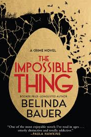 Front cover of The Impossible Thing: an illustration of a large golden egg against a black background