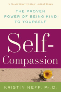 Front cover of Self-Compassion including a photo of a single yellow flower blooming in the sand