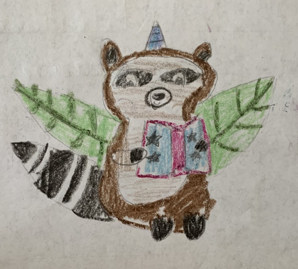 Crayon drawing of a seated brown raccoon with a blue unicorn horn. It has large green leaves for wings and is holding a blue and pink book with black stars on the cover.