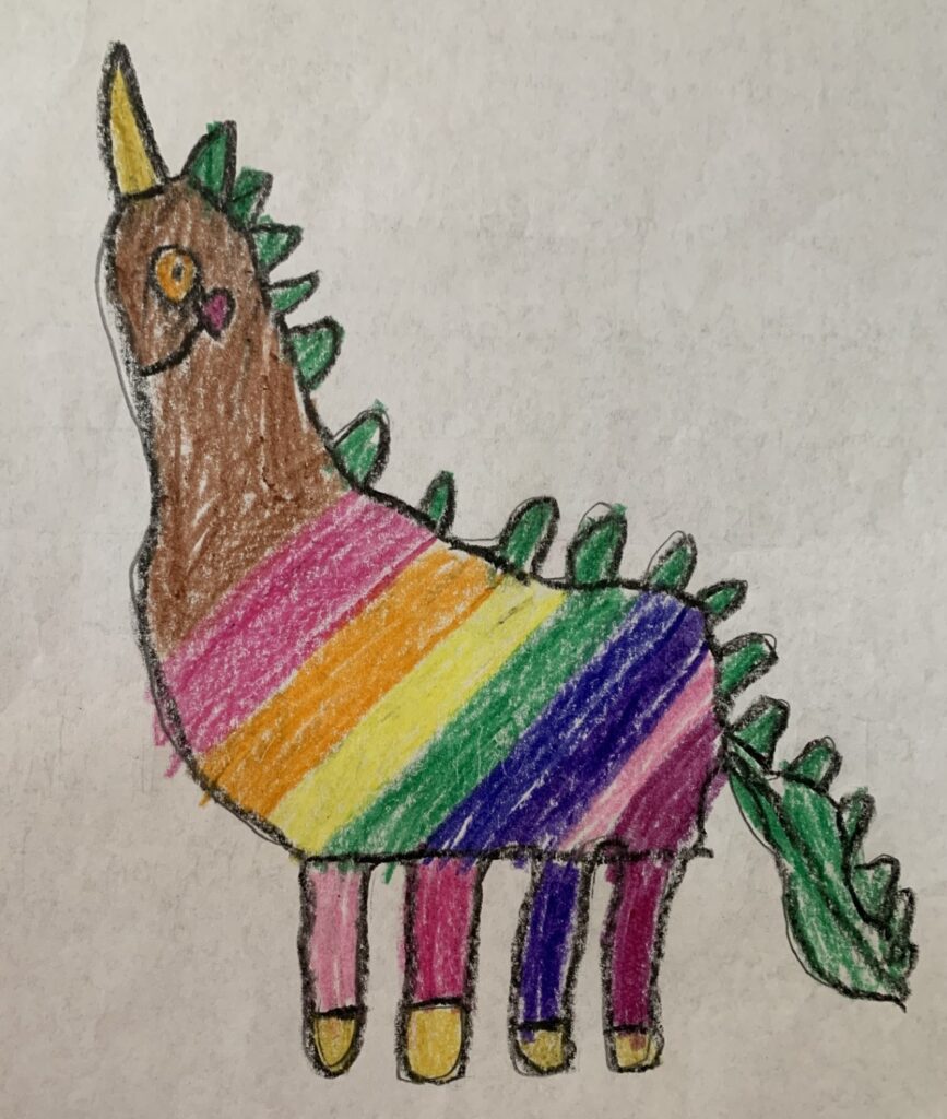 A crayon drawing of a smiling unicorn with rosy cheeks and a brown head. It has many green spines and a long green tail. Its main body and legs are rainbow colored.