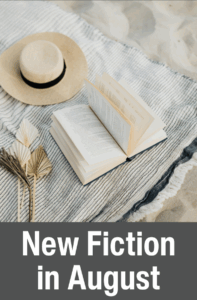 new fiction in august with an open book on a blanket on the beach