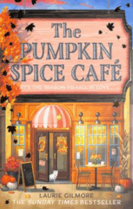 Cozy café setting adorned with autumn leaves, pumpkins, and festive seasonal decorations in warm, inviting colors.
