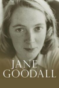 of a young Jane Goodall, her expression calm and thoughtful, with a plain dark background.