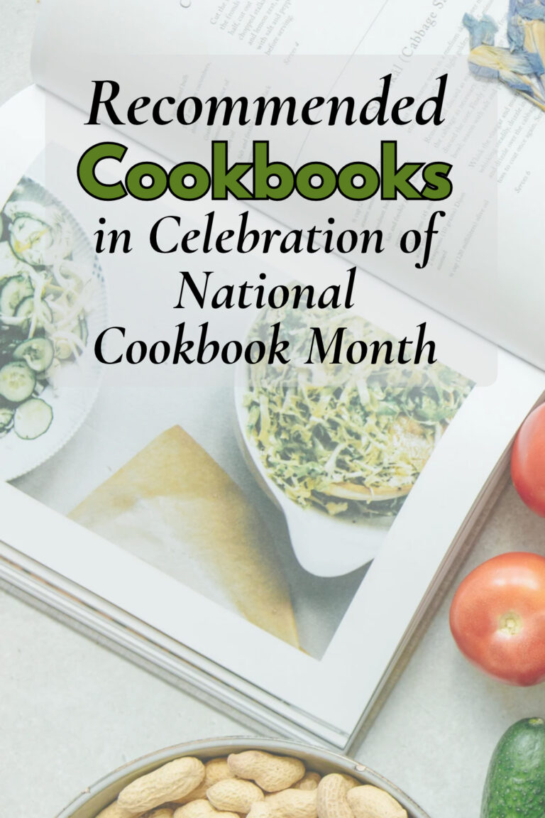 Open cookbook pages displayed alongside fresh tomatoes and a bowl of peanuts.