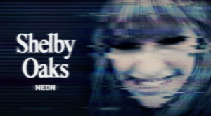 A smiling person is depicted in a video still featuring a glitch effect with the text Shelby Oaks and NEON.