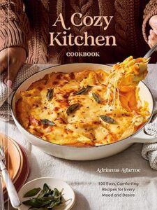 Book cover featuring a person serving a cheesy, herb-topped baked pasta dish from a white skillet.