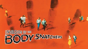 Movie art showing small figures running across a bright orange background patterned with a large, dark human handprint.