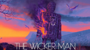 Movie art showing an illustration of a large burning wicker figure on a cliffside, with seagulls flying against a colorful sunset.